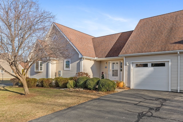 view of front of property with a front lawn and a garage