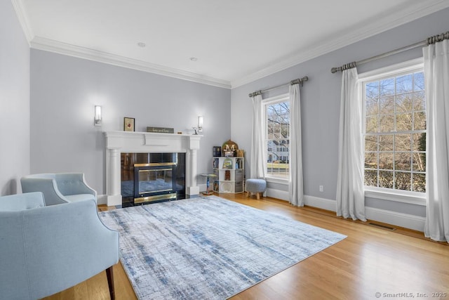 living room with crown molding and light wood-type flooring