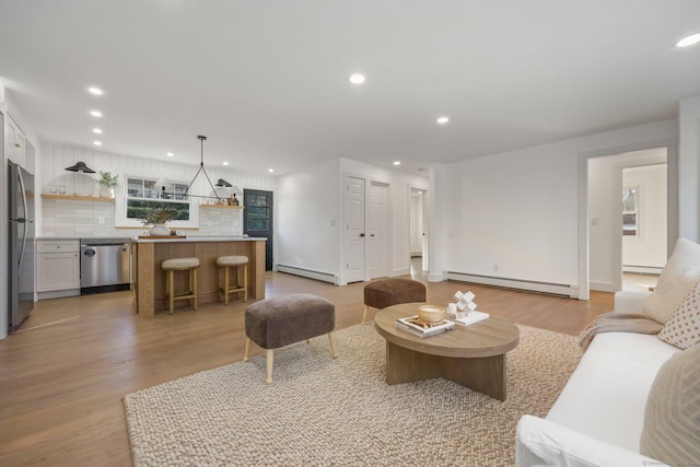 living room with light hardwood / wood-style flooring and a baseboard radiator