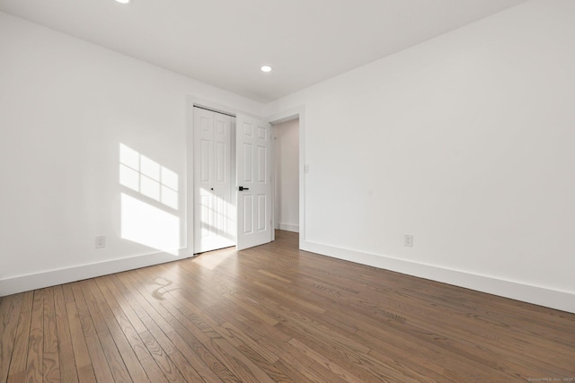 unfurnished room featuring dark hardwood / wood-style floors