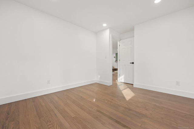 spare room featuring wood-type flooring