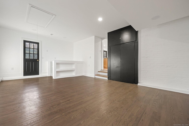 unfurnished living room with dark hardwood / wood-style flooring and built in features