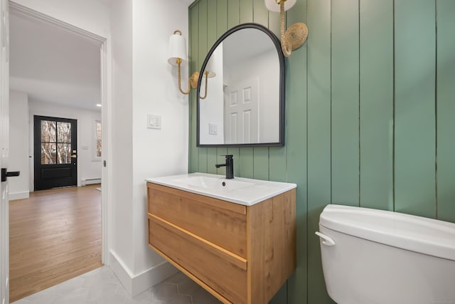 bathroom with baseboard heating, tile patterned floors, vanity, and toilet