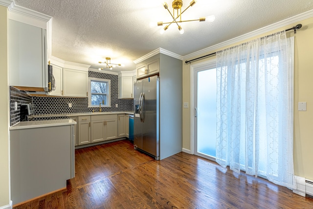 kitchen with sink, dark hardwood / wood-style floors, ornamental molding, tasteful backsplash, and stainless steel fridge with ice dispenser