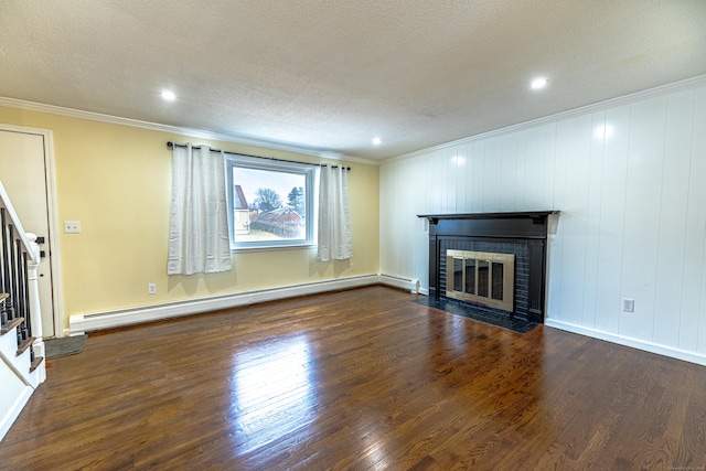 unfurnished living room with a brick fireplace, ornamental molding, a textured ceiling, baseboard heating, and dark hardwood / wood-style flooring