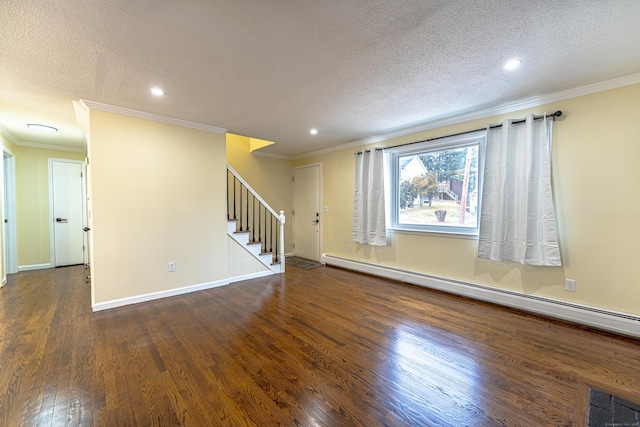 spare room featuring baseboard heating, dark hardwood / wood-style flooring, and ornamental molding