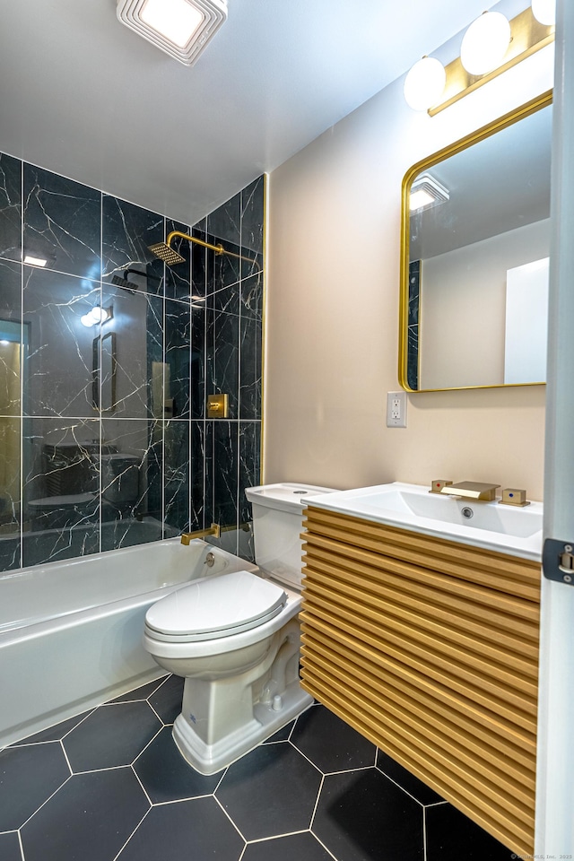 full bathroom featuring tile patterned flooring, vanity, tiled shower / bath combo, and toilet