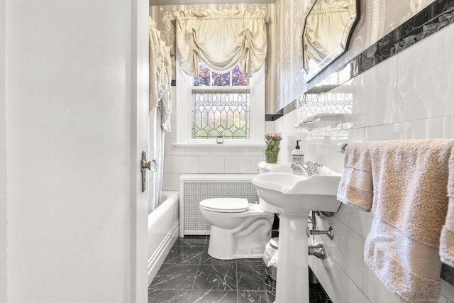 bathroom featuring shower / tub combination, tile walls, and toilet