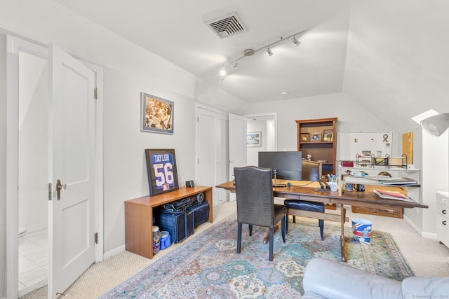 carpeted home office with vaulted ceiling