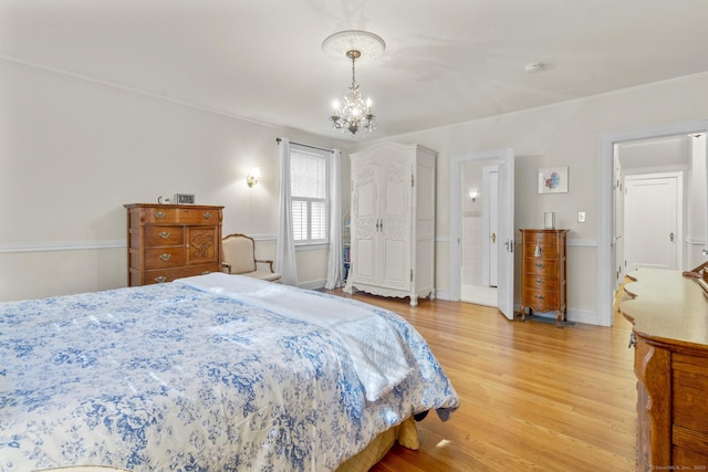 bedroom featuring hardwood / wood-style floors and an inviting chandelier