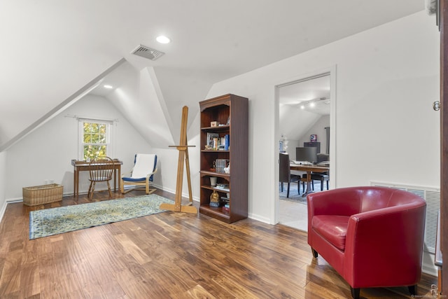 living area featuring wood-type flooring and lofted ceiling