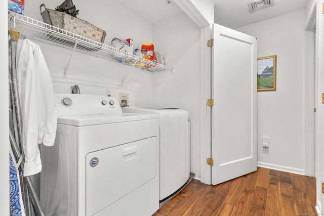 laundry room with dark hardwood / wood-style flooring and independent washer and dryer