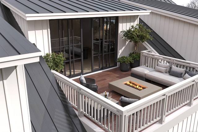 view of patio / terrace featuring a wooden deck and an outdoor fire pit