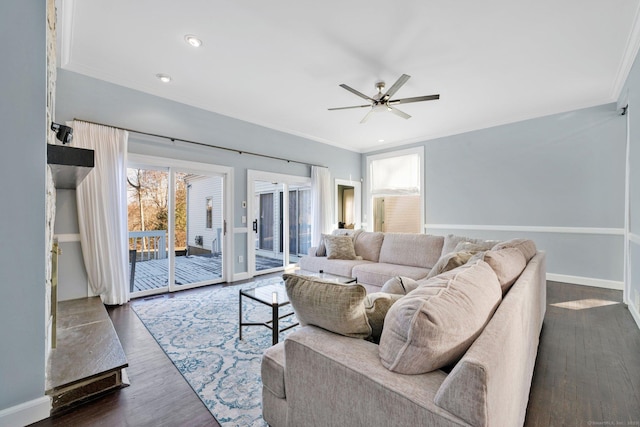 living room featuring ceiling fan, crown molding, and dark hardwood / wood-style floors