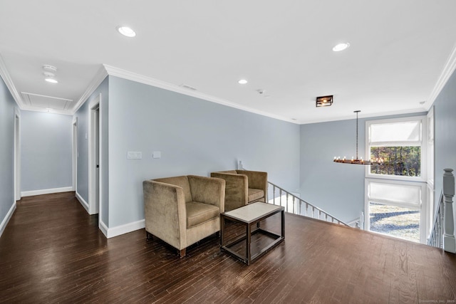 sitting room with a notable chandelier, dark hardwood / wood-style flooring, and crown molding