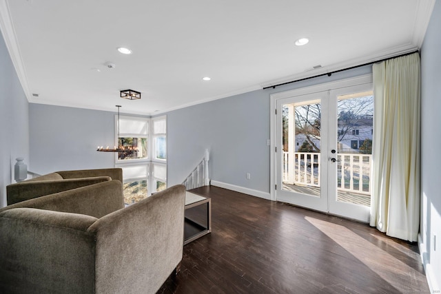 living room with french doors, dark hardwood / wood-style flooring, an inviting chandelier, and ornamental molding