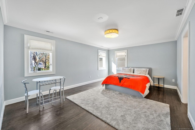 bedroom with multiple windows, dark hardwood / wood-style flooring, and ornamental molding