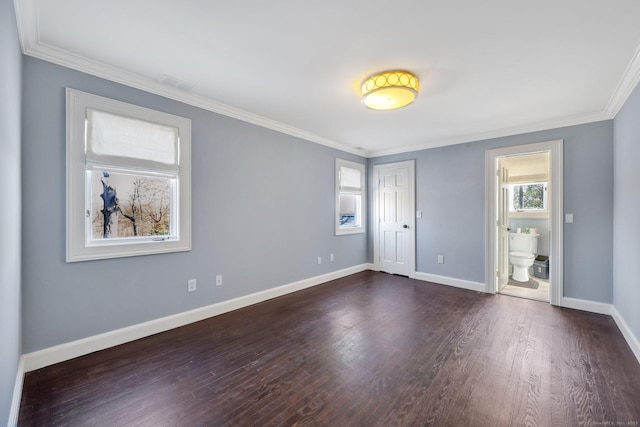 spare room with ornamental molding and dark wood-type flooring