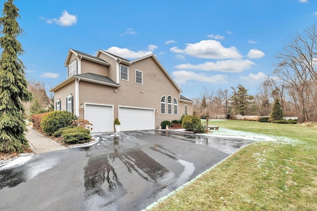 view of home's exterior with a lawn and a garage