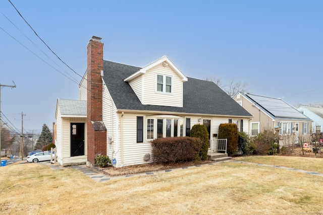 cape cod home with a front yard