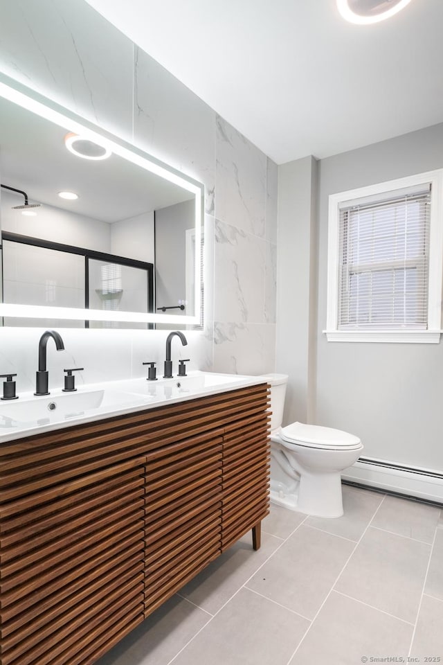 bathroom with toilet, a baseboard radiator, tile walls, tile patterned floors, and vanity