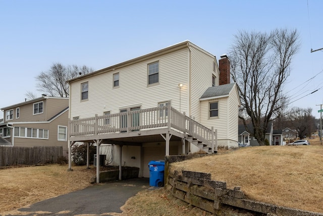 rear view of house featuring a deck and central AC