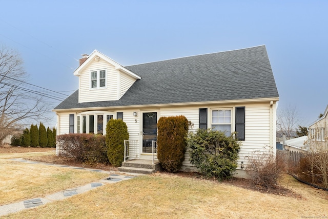 cape cod-style house featuring a front lawn