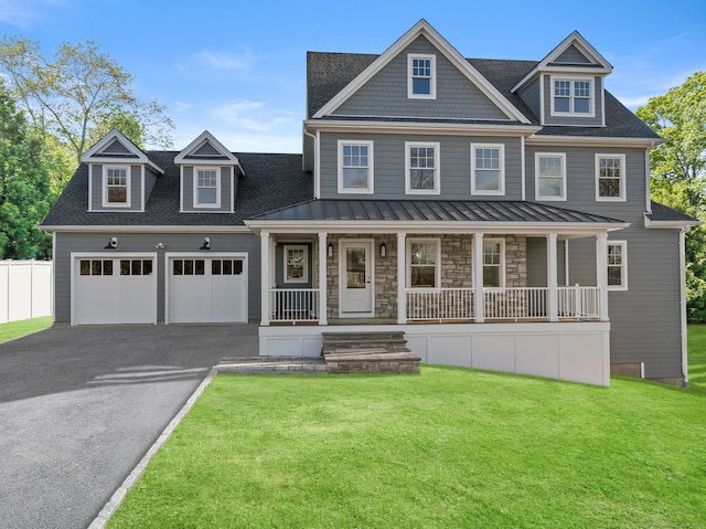 view of front of home featuring a front yard, a porch, and a garage