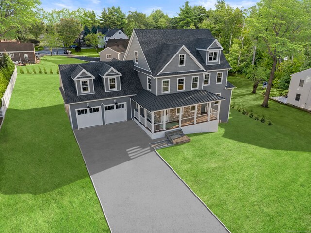 view of front facade with a front lawn, a porch, and a garage