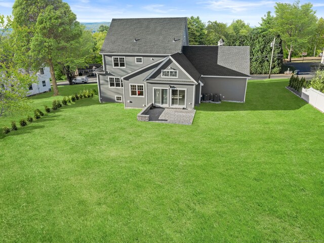 rear view of house featuring a patio area and a yard