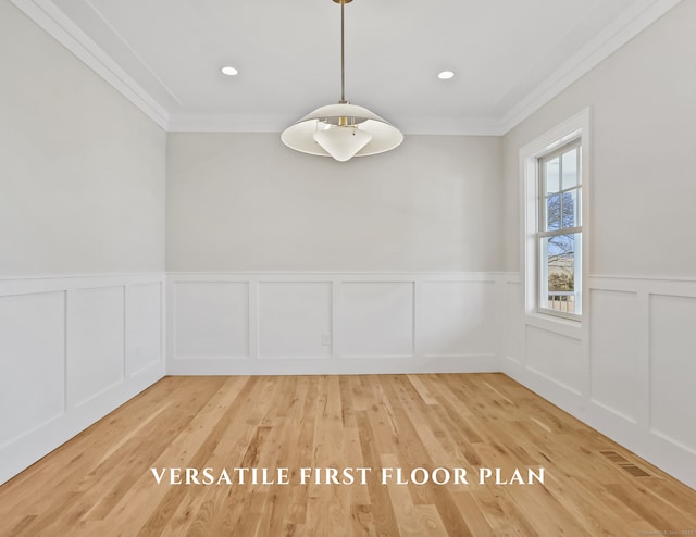 spare room with crown molding and light wood-type flooring