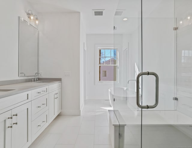 bathroom featuring walk in shower, tile patterned floors, and vanity