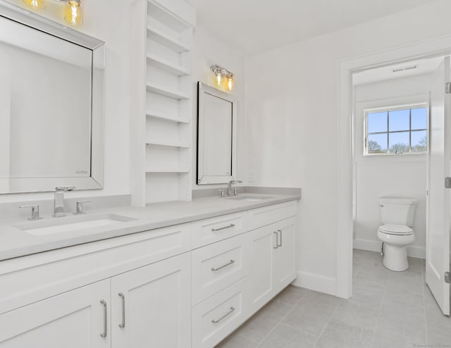 bathroom featuring vanity, toilet, and tile patterned flooring