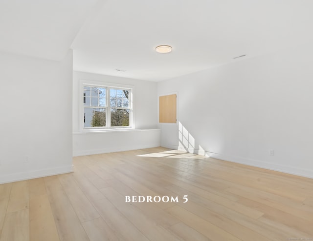 unfurnished room with light hardwood / wood-style floors