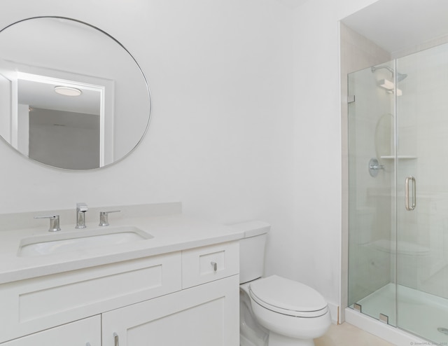 bathroom featuring vanity, toilet, and walk in shower