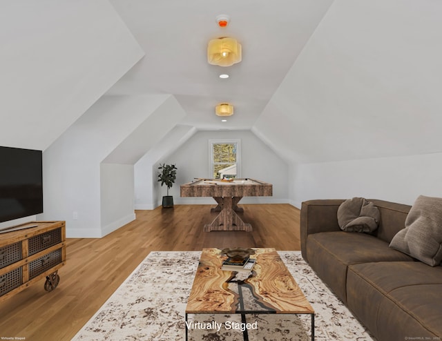 living room featuring vaulted ceiling and hardwood / wood-style floors