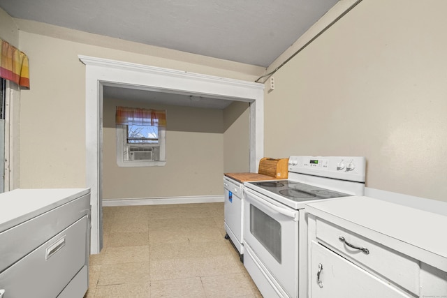 kitchen featuring washer / dryer, white electric range, and white cabinets