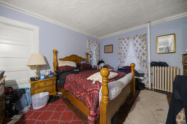 bedroom with a textured ceiling, ornamental molding, and radiator