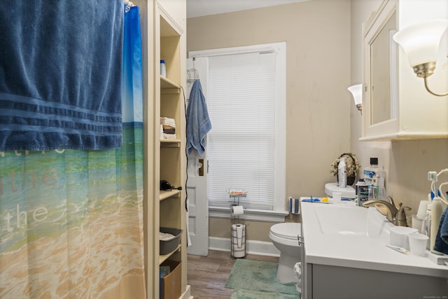 bathroom featuring hardwood / wood-style floors, vanity, and toilet