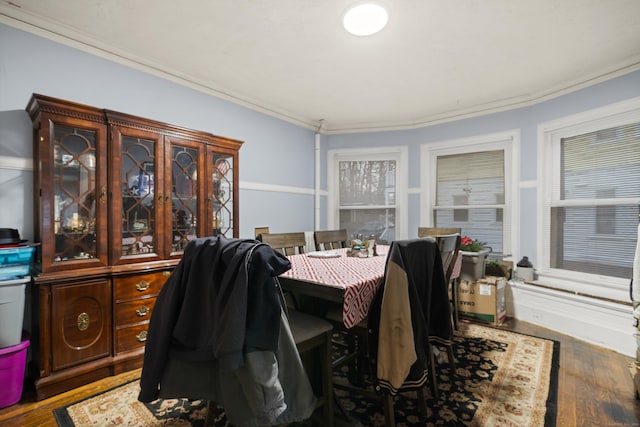 dining room with hardwood / wood-style floors and crown molding