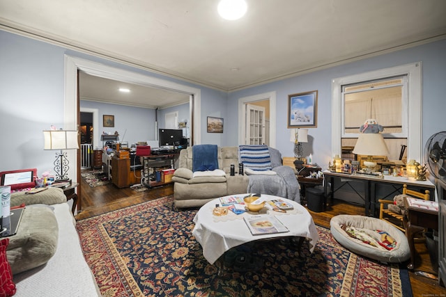 living room featuring dark wood-type flooring and ornamental molding