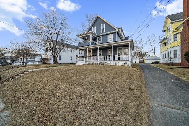 view of front facade featuring covered porch and a front lawn