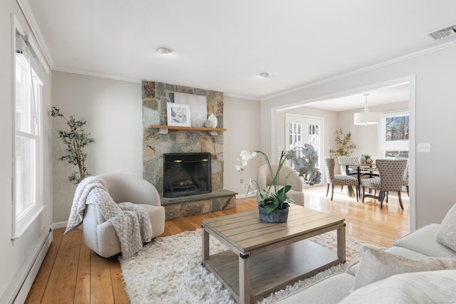 living room featuring hardwood / wood-style floors, crown molding, and a baseboard radiator