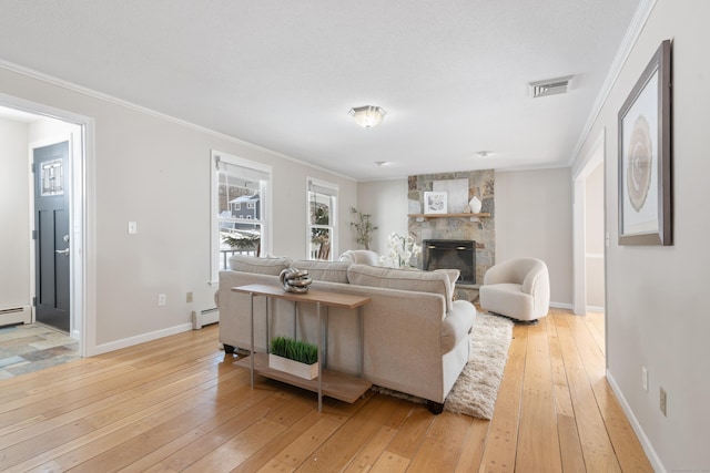 living room with a baseboard heating unit, crown molding, light hardwood / wood-style flooring, and a stone fireplace