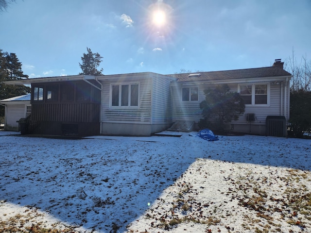 snow covered property featuring central AC