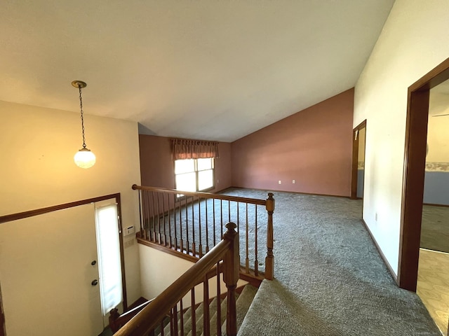 corridor featuring carpet floors and lofted ceiling