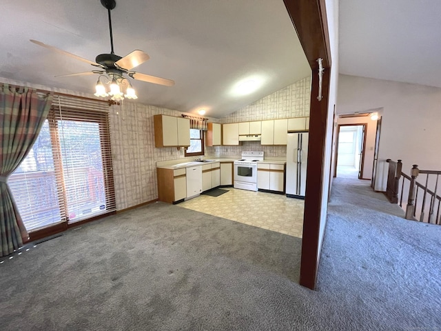 kitchen with backsplash, vaulted ceiling, light colored carpet, and white appliances