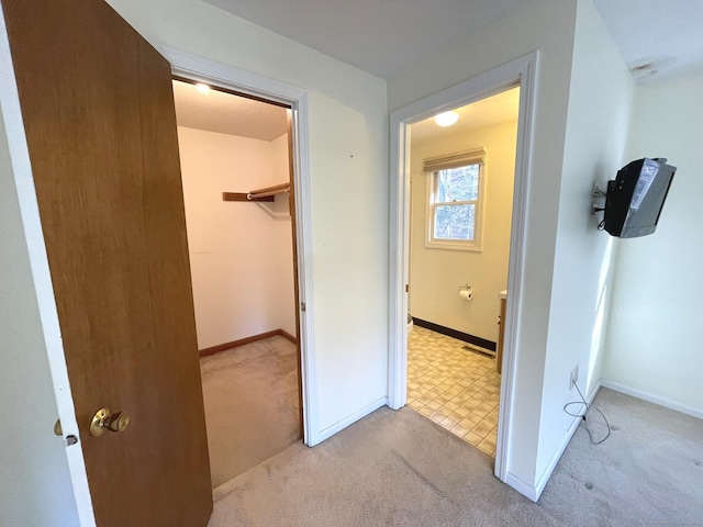 hall with light colored carpet