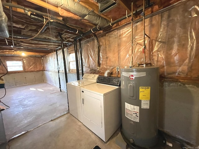 basement featuring washing machine and clothes dryer and electric water heater