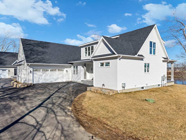 view of front of property with a garage and a front lawn